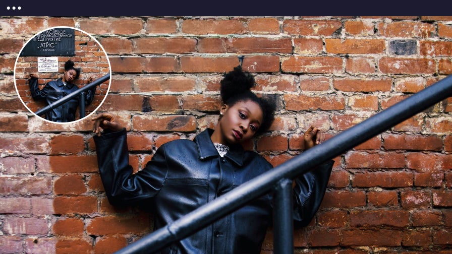 Woman posing by brick wall after using object remover to remove unwanted railing.