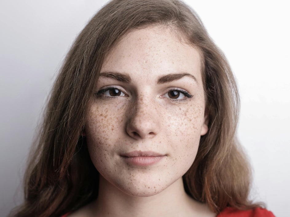 Before: Dull headshot of female model with low contrast