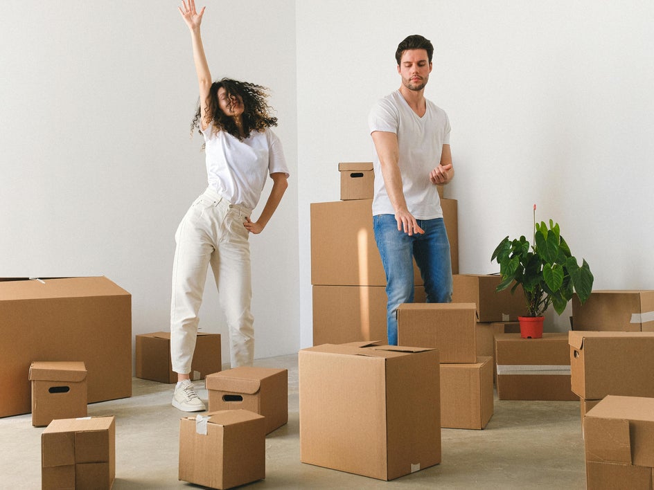 Before: happy couple surrounded by moving boxes