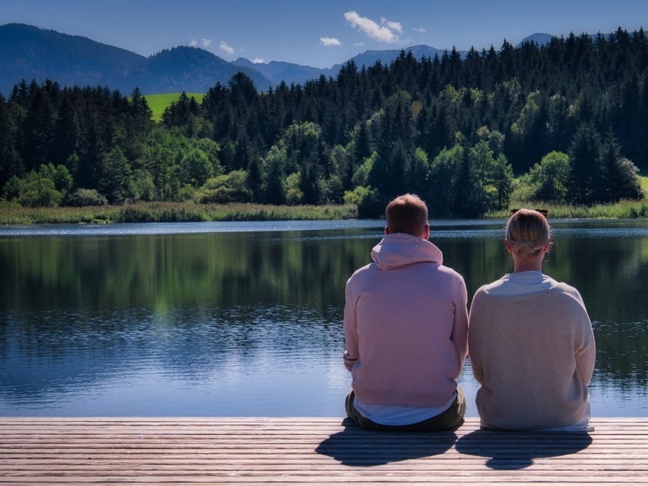 Before: Couple sitting on dock overlooking lake