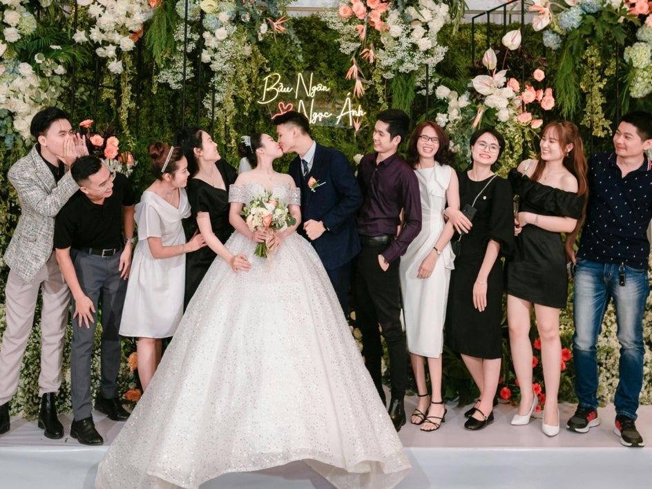 Before: Wedding party photo with couple in center