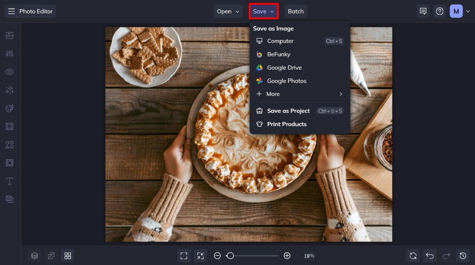 Same pie photo after object removal. The surrounding baking mess has been erased, leaving a clean wood table with the pie as the central focus. Save this image in save tab.
