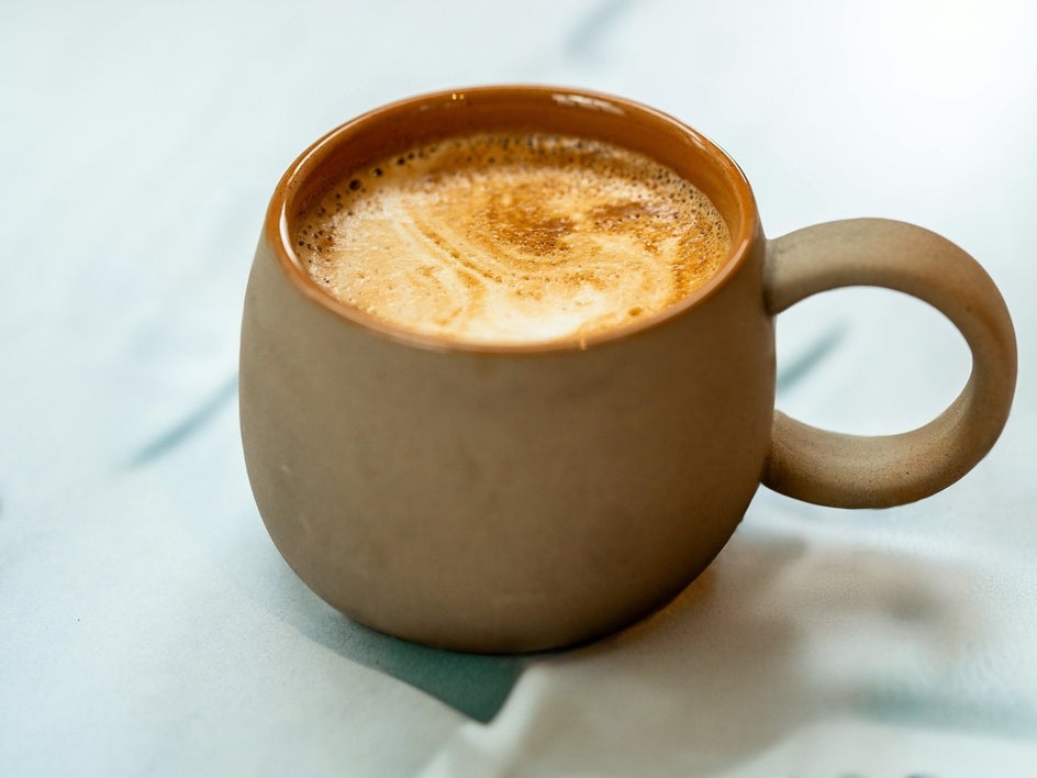 After: Coffee beans and background distractions have been erased, leaving a simplified and polished product shot.