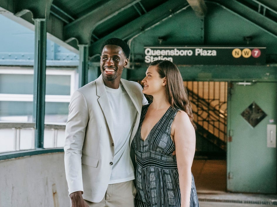 before: couple in train station with station name in background