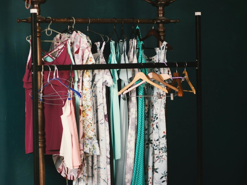 Before: Rack of clothing with extra hangers and unkept clothing