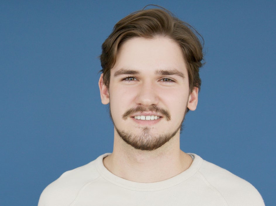 Before: Headshot with visible flyaway hairs before retouching with the Clone Tool