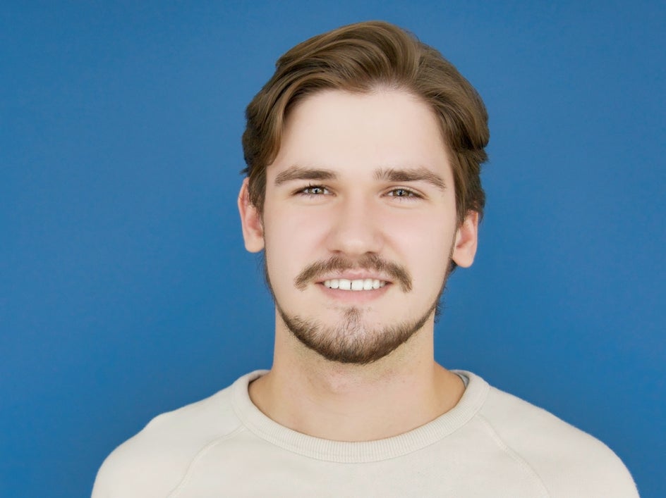 After: Retouched headshot with flyaways blended into the background using BeFunky’s Clone Tool