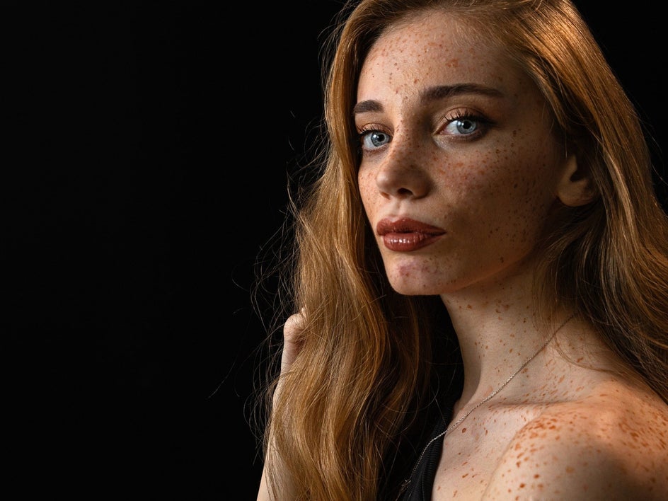 Before: Female model with long red hair and dramatic makeup.